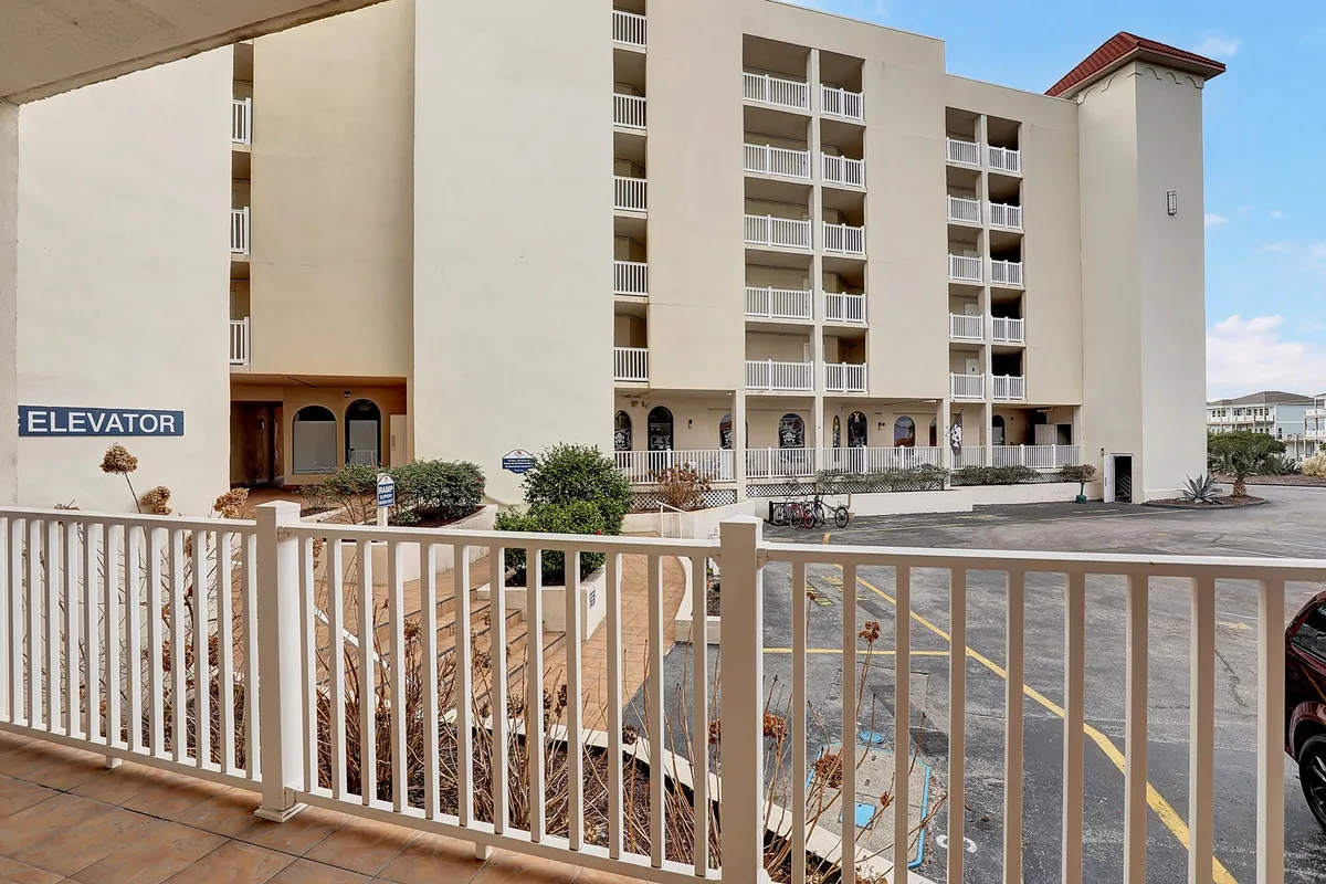 The exterior of the building is captured with elevator signage, a landscaped area, and a bicycle rack nearby, suggesting ease of access for guests as well as a welcoming, active environment. The facade offers a sense of place and connection to the surrounding neighborhood.
